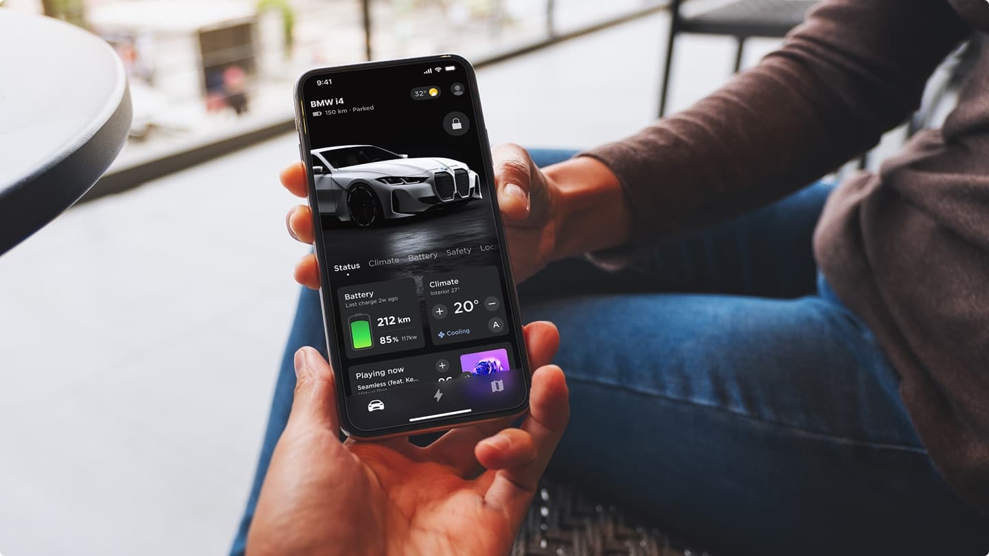 BMW companion app in-hand — vehicle status with battery, climate, and media controls